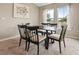 Inviting dining area with large windows offering serene views and a modern dining set at 4444 Quartz Ct, Lakeland, FL 33811