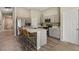 Modern kitchen with a spacious island, stainless steel appliances, and sleek countertops at 4444 Quartz Ct, Lakeland, FL 33811