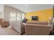 Comfortable living area featuring plush seating, abundant natural light, and views of the backyard at 4444 Quartz Ct, Lakeland, FL 33811
