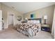 Spacious main bedroom offering a comfortable bed, neutral tones, and ample natural light at 4444 Quartz Ct, Lakeland, FL 33811