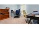 Home office featuring a dual desk layout, shelving unit, carpet floors, and office chair at 4444 Quartz Ct, Lakeland, FL 33811