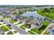 An aerial perspective displays houses along a pond, boasting beautiful landscaping and curb appeal at 4444 Quartz Ct, Lakeland, FL 33811