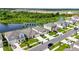 An aerial view captures a neighborhood with well-maintained lawns and a serene pond, enhancing the curb appeal at 4444 Quartz Ct, Lakeland, FL 33811