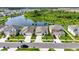 Aerial view shows a neighborhood with manicured lawns and a tranquil pond, highlighting a lovely community at 4444 Quartz Ct, Lakeland, FL 33811