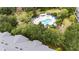 Aerial perspective of a resort-style pool area surrounded by lush greenery and comfortable lounge seating at 515 Rum Run # 33515, Davenport, FL 33897
