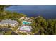 Aerial view of the building with lush landscaping, pool, lake, and dock at 515 Rum Run # 33515, Davenport, FL 33897