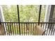 Secluded balcony offering peaceful views of lush trees and inviting seating area at 515 Rum Run # 33515, Davenport, FL 33897