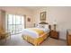 Bright bedroom featuring a bed, two side tables, lamps, decorative pillows, and curtains at 515 Rum Run # 33515, Davenport, FL 33897