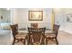 Dining room with glass table and seating for four, decorative parrot, and framed artwork at 515 Rum Run # 33515, Davenport, FL 33897