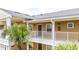 Close-up of a condo building exterior with a balcony and palm trees at 515 Rum Run # 33515, Davenport, FL 33897
