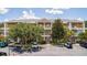 Condo building with parking lot, trees, and multiple balconies at 515 Rum Run # 33515, Davenport, FL 33897