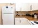 Traditional kitchen featuring white cabinets, brown countertops, and modern appliances at 515 Rum Run # 33515, Davenport, FL 33897