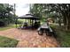 Outdoor picnic area with barbecue grills and picnic tables, surrounded by trees and landscaping at 515 Rum Run # 33515, Davenport, FL 33897