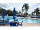 Community pool with clear water, seating, umbrellas, and tropical landscaping at 515 Rum Run # 33515, Davenport, FL 33897