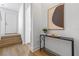 Bright entryway features hardwood floors, a modern console table with decor, and stairs leading to the upper level at 52 W Harding St # A, Orlando, FL 32806