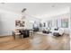 Open-concept living space features modern furnishings, wood floors, and large windows for ample light at 52 W Harding St # A, Orlando, FL 32806