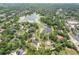 Aerial view of the property, showcasing the home, pool, and lake at 530 Lake Bingham Rd, Lake Mary, FL 32746