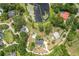 Aerial view of a home situated on a large lot with a lake and lush trees at 530 Lake Bingham Rd, Lake Mary, FL 32746