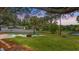 Expansive backyard with pool, fire pit, and large trees, perfect for outdoor living at 530 Lake Bingham Rd, Lake Mary, FL 32746