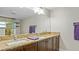 Bathroom featuring double sinks with dark wood cabinets and granite countertops at 530 Lake Bingham Rd, Lake Mary, FL 32746