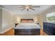 Inviting bedroom with hardwood floors, a large bed, and ample natural light at 530 Lake Bingham Rd, Lake Mary, FL 32746