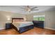 Cozy bedroom with hardwood floors, a large bed, and plenty of natural light from the window at 530 Lake Bingham Rd, Lake Mary, FL 32746