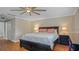 Well-lit bedroom featuring hardwood floors, a large bed, and soft, neutral decor at 530 Lake Bingham Rd, Lake Mary, FL 32746
