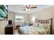 Bedroom featuring TV mounted on wall, ceiling fan and window with natural light at 530 Lake Bingham Rd, Lake Mary, FL 32746