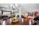 Elegant dining room featuring a modern light fixture and seamless flow into the cozy living room and kitchen at 530 Lake Bingham Rd, Lake Mary, FL 32746