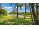 Scenic lake view framed by mature trees and lush greenery at 530 Lake Bingham Rd, Lake Mary, FL 32746