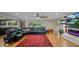 Spacious living room featuring a large leather sectional, hardwood floors and modern fireplace at 530 Lake Bingham Rd, Lake Mary, FL 32746