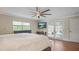 Bright main bedroom featuring a ceiling fan, TV, wood floors and access to a patio at 530 Lake Bingham Rd, Lake Mary, FL 32746