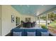 Outdoor patio with access to a pristine pool surrounded by lush greenery and trees at 530 Lake Bingham Rd, Lake Mary, FL 32746
