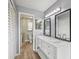 Bright bathroom featuring double sink vanity, modern lighting, and tiled floors at 5436 Tangerine Ave, Winter Park, FL 32792