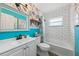 Unique bathroom with bright wallpaper, large mirror, and built-in tub at 5436 Tangerine Ave, Winter Park, FL 32792