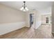 Inviting dining area features wainscoting, wood-look tile and access to multiple rooms at 5436 Tangerine Ave, Winter Park, FL 32792