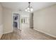 Dining room with wood-look tile leading into multiple rooms, including the living room at 5436 Tangerine Ave, Winter Park, FL 32792