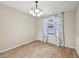 Comfortable dining area with wood-look tile, a chandelier, and natural light from the window at 5436 Tangerine Ave, Winter Park, FL 32792