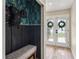 Stylish entryway with bench seating, wainscotting and decorative wallpaper at 5436 Tangerine Ave, Winter Park, FL 32792