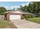 Well-maintained single-Gathering home with manicured lawn, brick facade, and two-car garage at 5436 Tangerine Ave, Winter Park, FL 32792