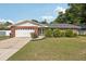 Charming single-story brick home with well-manicured front yard and two-car garage at 5436 Tangerine Ave, Winter Park, FL 32792