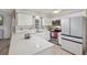 Bright kitchen with white cabinetry, modern appliances and quartz countertops at 5436 Tangerine Ave, Winter Park, FL 32792