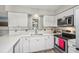 Updated kitchen featuring white cabinetry, stainless steel appliances and subway tile backsplash at 5436 Tangerine Ave, Winter Park, FL 32792