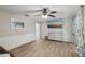 Comfortable living area with wood-look tile and a view into another room with sliding glass door at 5436 Tangerine Ave, Winter Park, FL 32792