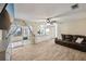 Open concept living area with wood-look tile, sliding glass doors, and a view into the kitchen at 5436 Tangerine Ave, Winter Park, FL 32792