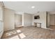 Bright living room featuring beautiful wood-look tile flooring and a neutral color palette at 5436 Tangerine Ave, Winter Park, FL 32792