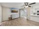 Open living area featuring wood-look tile, grey dresser and access to the kitchen at 5436 Tangerine Ave, Winter Park, FL 32792