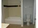 Bright bathroom featuring tub shower, neutral wall tiles, and modern toilet at 6021 Westgate Dr # 813, Orlando, FL 32835