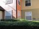 Exterior view of the building with multiple windows, manicured bushes, and multi-colored stucco at 6021 Westgate Dr # 813, Orlando, FL 32835