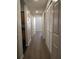 Hallway with hardwood floors leads to bedrooms and living areas, complemented by ample closet space at 6021 Westgate Dr # 813, Orlando, FL 32835